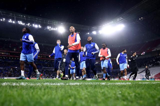 FC Saint-Cyr Collonges players warm up ahead of the French Cup round of 64 football match between - Olympique Lyonnais (OL) and Saint-Cyr-Collonges at the Groupama Stadium in Lyon, south eastern France on December 21, 2025. (Photo by Alex MARTIN / AFP)