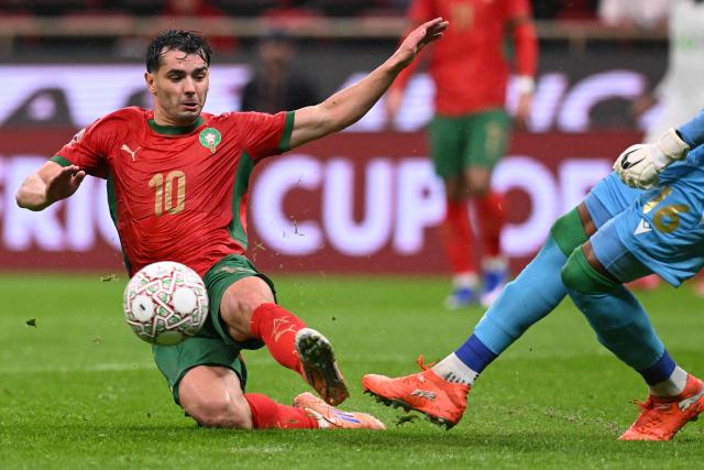 Morocco's forward #10 Brahim Diaz fights for the ball with Comoros's goalkeeper #16 Yannick Pandor during the Africa Cup of Nations (CAN) group A  football match between Morocco and Comoros at Prince Moulay Abdellah Stadium in Rabat on December 21, 2025. (Photo by SEBASTIEN BOZON / AFP)