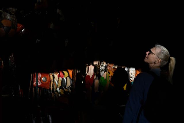 A tourist looks at leather goods in a shop at the old market of Marrakech city on December 21, 2025, during the Africa Cup of Nations (CAN) football tournament. (Photo by Khaled DESOUKI / AFP)