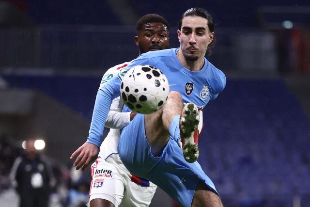 FC Saint-Cyr Collonges' French midfielder Hamza Baali controls the ball during the French Cup round of 64 football match between Olympique Lyonnais (OL) and Saint-Cyr-Collonges at the Groupama Stadium in Lyon, south eastern France on December 21, 2025. (Photo by Alex MARTIN / AFP)