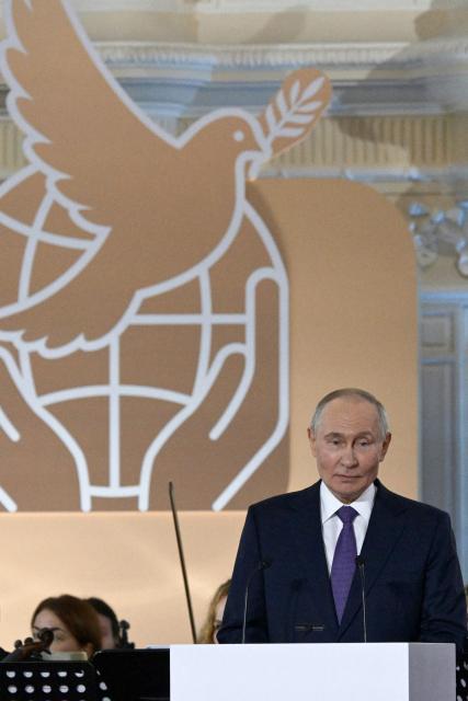 In this pool photograph distributed by Russian state agency Sputnik, Russia's President Vladimir Putin addresses the audience during the Leo Tolstoy International Peace Prize ceremony following the informal summit of Commonwealth of Independent States (CIS) leaders in Saint Petersburg on December 21, 2025. (Photo by Alexey DANICHEV / POOL / AFP)