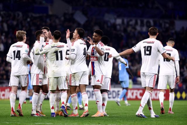Lyon's Czech midfielder Pavel Sulc #14 (L) celebrates with his teammates after scoring his team's third goal during the French Cup round of 64 football match between Olympique Lyonnais (OL) and Saint-Cyr-Collonges at the Groupama Stadium in Lyon, south eastern France on December 21, 2025. (Photo by Alex MARTIN / AFP)