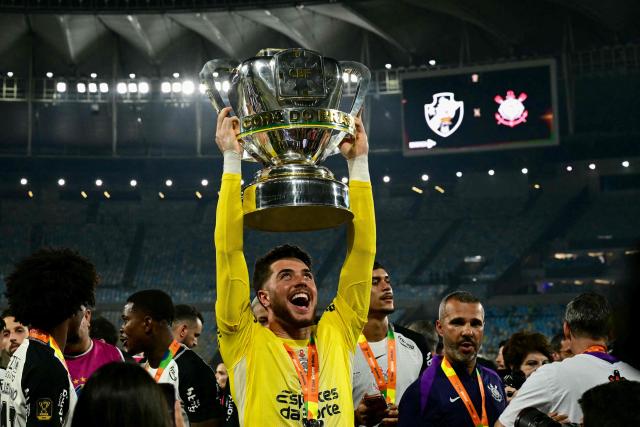 Corinthians' goalkeeper #40 Felipe Longo lifts the trophy of the Brazil Cup after the final second leg football match between Vasco da Gama and Corinthians at the Maracana stadium in Rio de Janeiro, Brazil on December 21, 2025. (Photo by Pablo PORCIUNCULA / AFP)