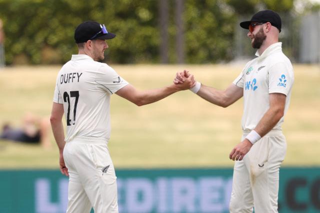 New Zealand’s Jacob Duffy (L) and Michael Rae shake hands during day five of the 3rd international Test cricket match between New Zealand and West Indies at Bay Oval in Mount Maunganui, Tauranga, New Zealand on December 22, 2025. (Photo by Michael Bradley / AFP)