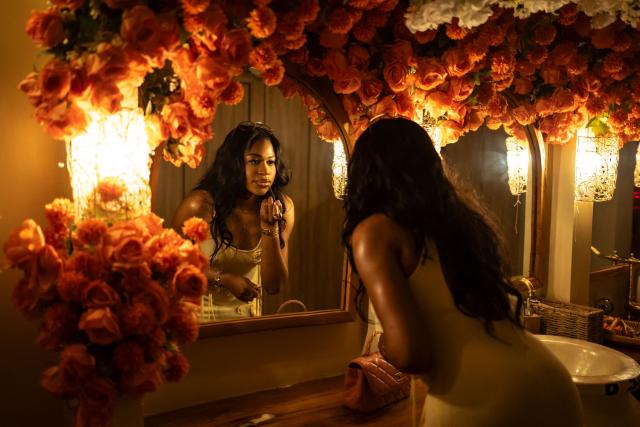 A patron arranges her makeup inside the restroom of the Lulu beach club during its opening during “Detty December” in Lagos on November 22, 2025. “Detty December” refers to the lively Lagos tradition where December is packed with nonstop parties, concerts, nightlife, and cultural events, fuelled by returning diaspora Nigerians and heightened local celebration. The city becomes especially vibrant and crowded as entertainment and tourism peak. The spelling “detty” comes from Nigerian Pidgin English, where it is a playful version of “dirty” that implies excess, intensity, and carefree fun. (Photo by OLYMPIA DE MAISMONT / AFP)