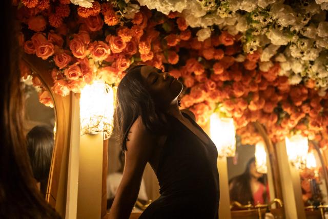 A patron stands by the sinks inside the restroom of the Lulu beach club during its opening during “Detty December” in Lagos on November 22, 2025. “Detty December” refers to the lively Lagos tradition where December is packed with nonstop parties, concerts, nightlife, and cultural events, fuelled by returning diaspora Nigerians and heightened local celebration. The city becomes especially vibrant and crowded as entertainment and tourism peak. The spelling “detty” comes from Nigerian Pidgin English, where it is a playful version of “dirty” that implies excess, intensity, and carefree fun. (Photo by OLYMPIA DE MAISMONT / AFP)