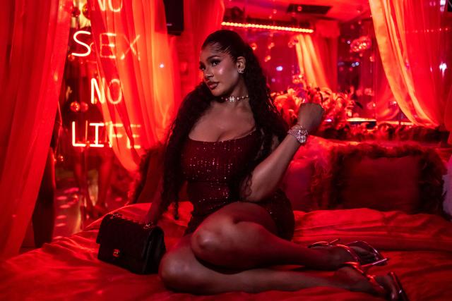 A patron poses for a photograph on a bed in a decorated selfie space inside the restroom of the Lulu beach club during its opening during “Detty December” in Lagos on November 22, 2025. “Detty December” refers to the lively Lagos tradition where December is packed with nonstop parties, concerts, nightlife, and cultural events, fuelled by returning diaspora Nigerians and heightened local celebration. The city becomes especially vibrant and crowded as entertainment and tourism peak. The spelling “detty” comes from Nigerian Pidgin English, where it is a playful version of “dirty” that implies excess, intensity, and carefree fun. (Photo by OLYMPIA DE MAISMONT / AFP)