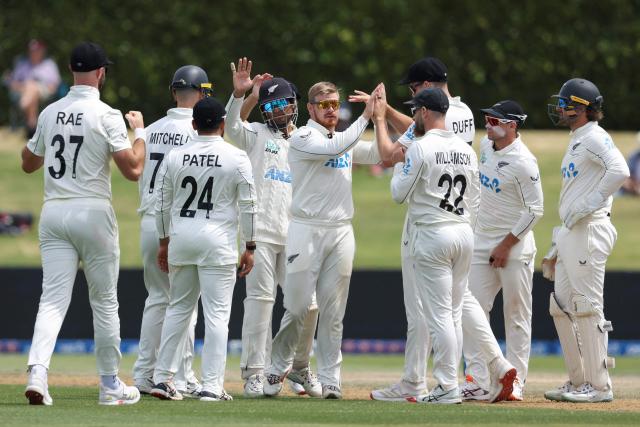 New Zealand’s Glenn Phillips (C) celebrates the wicket of West Indies' Kemar Roach during day five of the 3rd international Test cricket match between New Zealand and West Indies at Bay Oval in Mount Maunganui, Tauranga, New Zealand on December 22, 2025. (Photo by Michael Bradley / AFP)