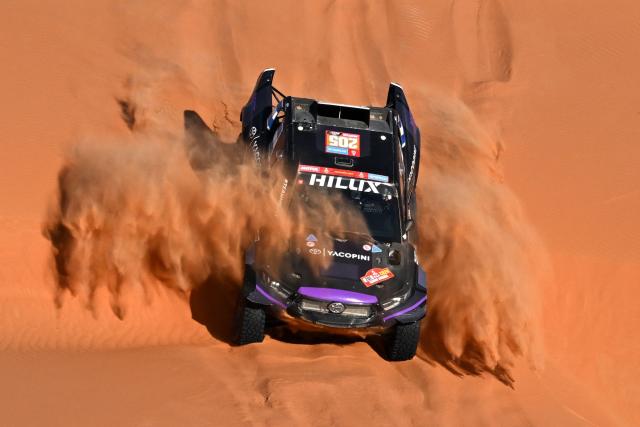 (FILES) Team Overdrive Racing's Argentinian driver Juan Cruz Yacopini and his Spanish co-driver Daniel Oliveras Carreras steer their car during stage 6 of the Dakar rally 2024, a 48h-chrono stage between Shubaytah and Shubaytah, Saudi Arabia, on January 11, 2024. Argentine driver Juan Cruz Yacopini is hospitalized after a serious accident during his vacation in the Argentine province of Mendoza and will not participate in the 2026 Dakar Rally, his team reported on December 21, 2025. (Photo by PATRICK HERTZOG / AFP)