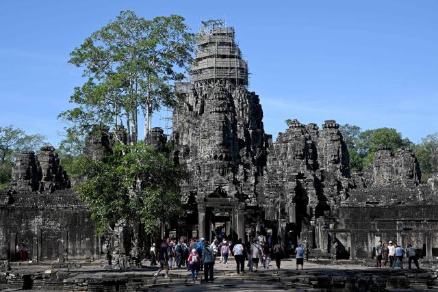 This photo taken on December 18, 2025 shows tourists visiting the Bayon temple in Siem Reap province.  (Photo by TANG CHHIN Sothy / AFP)
