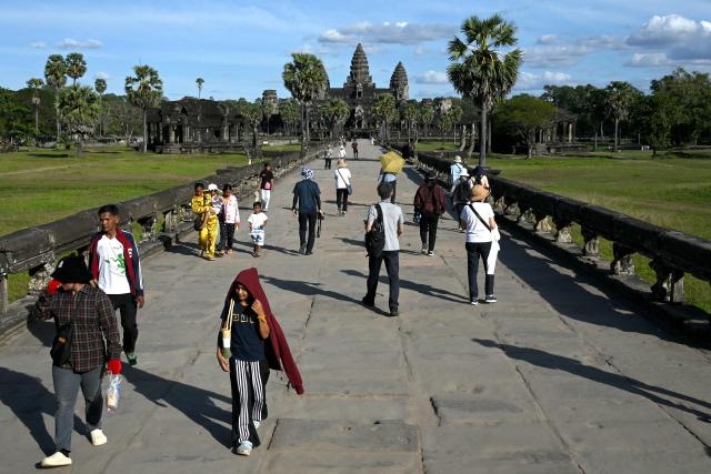This photo taken on December 18, 2025 shows tourists visiting the Angkor Wat temple in Siem Reap province.  (Photo by TANG CHHIN Sothy / AFP)