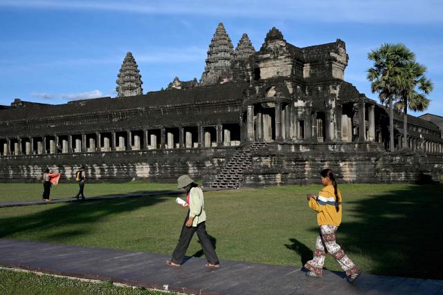 This photo taken on December 18, 2025 shows tourists visiting the Angkor Wat temple in Siem Reap province.  (Photo by TANG CHHIN Sothy / AFP)
