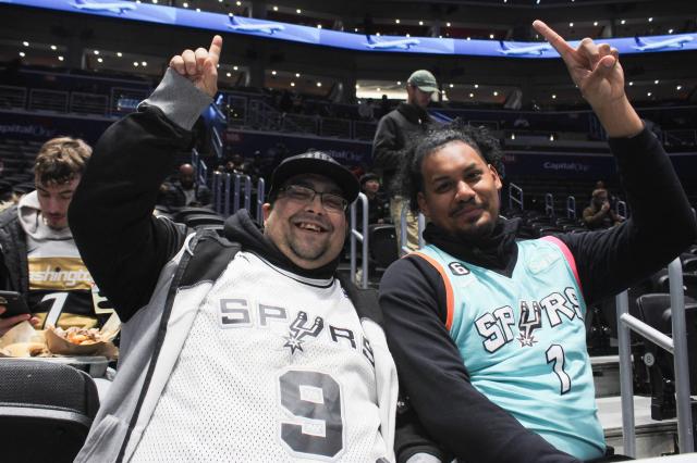 San Antonio Spurs fans Nelson Jones, 33 (R), and his friend Chris Shelton, 41, attend the Spurs–Wizards game at Capital One Arena in Washington, DC, on December 21, 2025. (Photo by Paul NOLP / AFP)