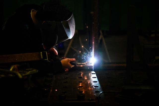 A student welds metal pieces at a metal workshop of the Lycee des Metiers du Batiment (LMB - Building Trades High School), which provides instruction to high school students and over 100 university students in the construction and architecture fields in Felletin on December 10, 2025. (Photo by Christophe ARCHAMBAULT / AFP)