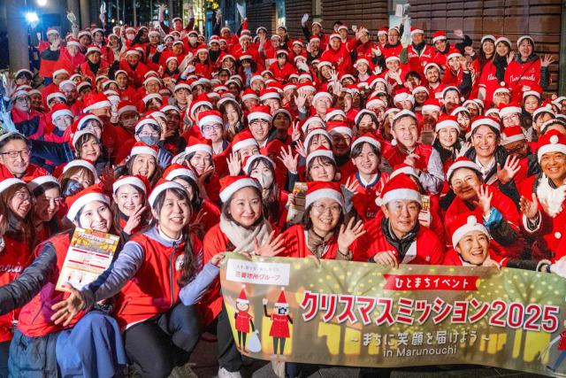 Office workers dressed as Santa Claus in Tokyo's Marunouchi business district participate in "Christmas Mission 2025," an event to liven up the area during the festive season, on December 22, 2025. (Photo by Kazuhiro NOGI / AFP)