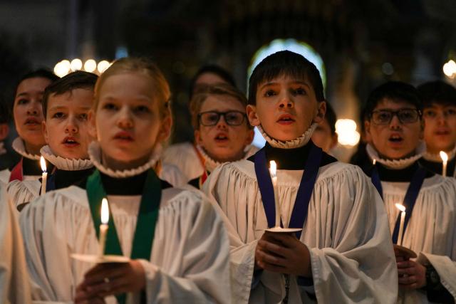 Choristers take part in a rehearsal for their upcoming Christmas performances, at St Paul's Cathedral in central London on December 22, 2025. (Photo by CARLOS JASSO / AFP)