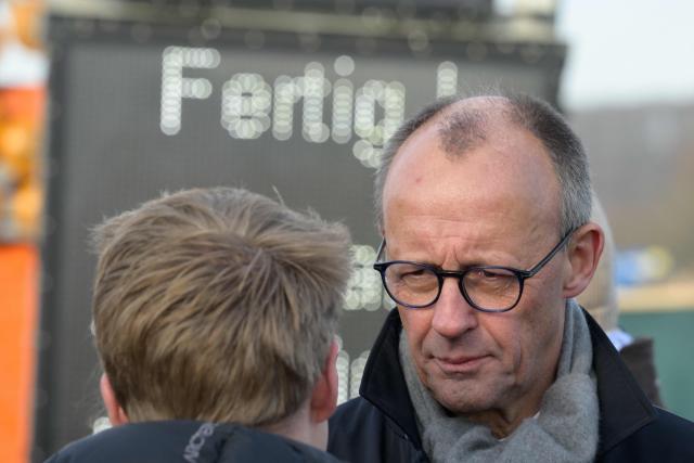 German Chancellor Friedrich Merz speaks to journalists at the opening ceremony for the reconstructed Rahmede bridge on the A45 motorway, near Luedenscheid, western Germany on December 22, 2025. Following a routine inspection of the Rahmede viaduct in December 2021, inspectors discovered deformations in the steel wall that could affect the bridge's load-bearing capacity, leading to its reconstruction. (Photo by Sascha Schuermann / AFP)