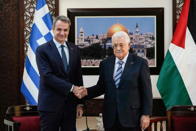 Palestinian president Mahmud Abbas (R) meets with Greek Prime Minister Kyriakos Mitsotakis in Ramallah in the Israeli-occupied West Bank, on December 22, 2025. (Photo by Nasser Nasser / POOL / AFP)