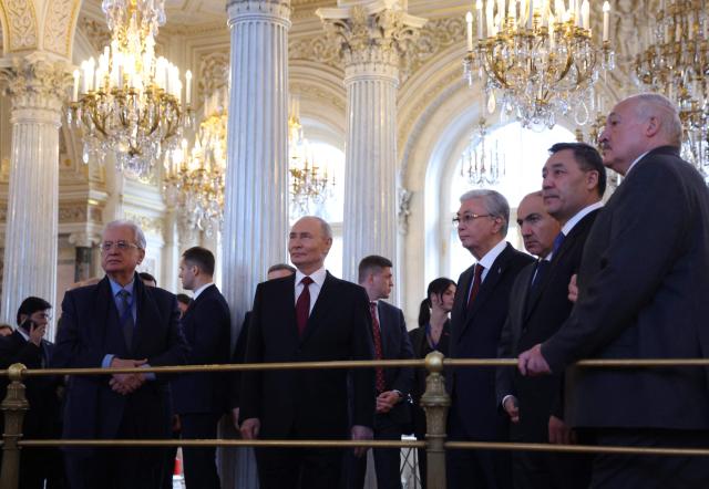 In this pool photograph distributed by the Russian state agency Sputnik, participants of an informal summit of the Commonwealth of Independent States (CIS) leaders, including Russia's President Vladimir Putin, tour the State Hermitage Museum in Saint Petersburg on December 22, 2025. (Photo by Alexander KAZAKOV / POOL / AFP)