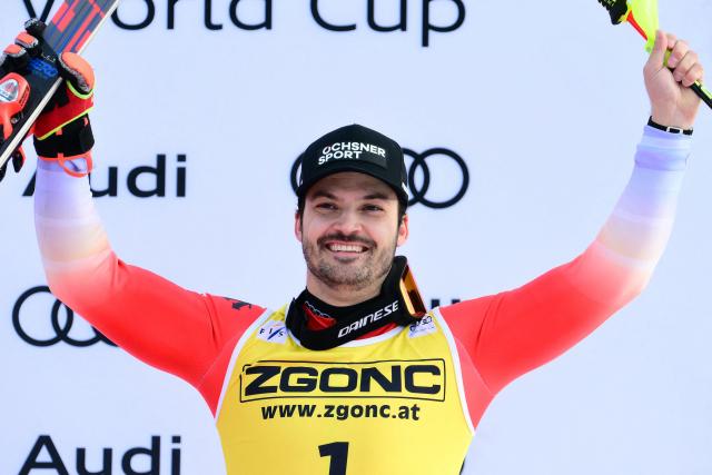 Third placed Switzerland's Loic Meillard celebrates on the podium of the Men's Slalom event, as part of the FIS Alpine Ski World Cup 2025-2026, in Alta Badia, northern Italy, on December 22, 2025. (Photo by Stefano RELLANDINI / AFP)