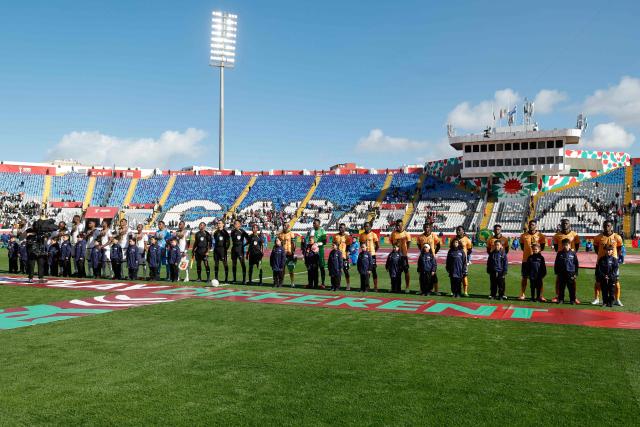 Players stand on the pitch ahead of the Africa Cup of Nations (AFCON) Group A football match between Mali and Zambia at Mohammed V Stadium in Casablanca, Morocco on December 22, 2025. (Photo by Abdel Majid BZIOUAT / AFP)