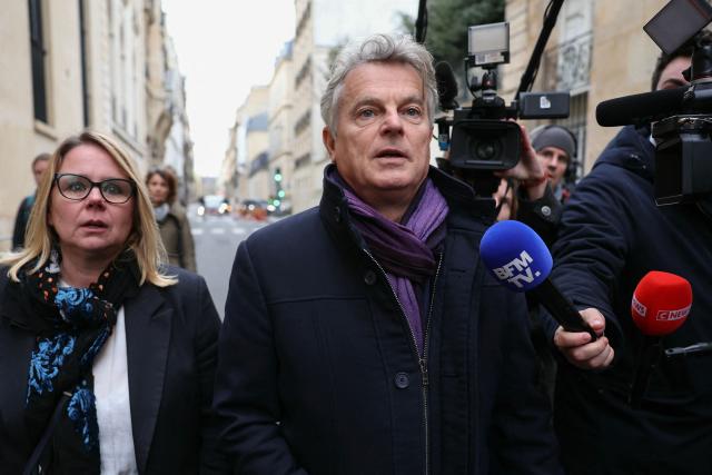 National secretary of French far-left Communist party (PCF) Fabien Roussel (C) and French PCF senator Cecile Cukierman (L) arrive for a meeting with France's Prime Minister at the Hotel Matignon in Paris on December 22, 2025, before a cabinet meeting at the end of the day to urgently present a "special bill" aimed at breaking the budget deadlock, following the failure of the parliamentary review of the state budget. A joint committee of French lawmakers on December 19, 2025 failed to reach a compromise on the state budget for next year, parliamentary sources said, meaning France would not have a 2026 budget by year end. The 2025 budget is now likely to be carried over into the new year as debates continue in both chambers. (Photo by Thomas SAMSON / AFP)