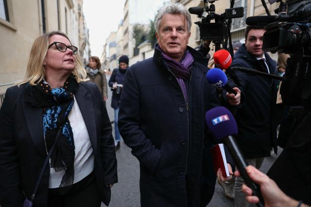 National secretary of French far-left Communist party (PCF) Fabien Roussel (C) and French PCF senator Cecile Cukierman (L) arrive for a meeting with France's Prime Minister at the Hotel Matignon in Paris on December 22, 2025, before a cabinet meeting at the end of the day to urgently present a "special bill" aimed at breaking the budget deadlock, following the failure of the parliamentary review of the state budget. A joint committee of French lawmakers on December 19, 2025 failed to reach a compromise on the state budget for next year, parliamentary sources said, meaning France would not have a 2026 budget by year end. The 2025 budget is now likely to be carried over into the new year as debates continue in both chambers. (Photo by Thomas SAMSON / AFP)
