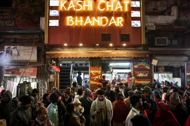 Tourists crowd outside a street food joint in Varanasi on December 22, 2025. (Photo by Niharika KULKARNI / AFP)
