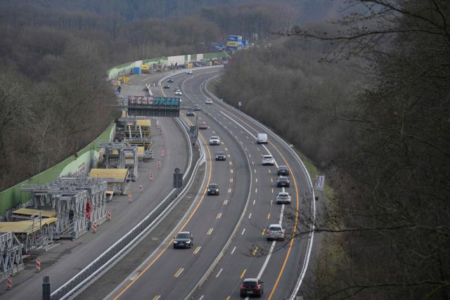 Traffic is pictured on the A45 motorway after the opening ceremony for the reconstructed Rahmede bridge near Luedenscheid, western Germany on December 22, 2025. Following a routine inspection of the Rahmede viaduct in December 2021, inspectors discovered deformations in the steel wall that could affect the bridge's load-bearing capacity, leading to its reconstruction. (Photo by Sascha Schuermann / AFP)