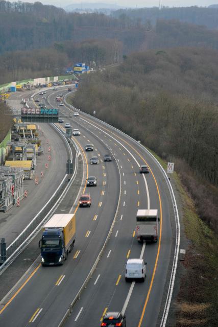 Traffic is pictured on the A45 motorway after the opening ceremony for the reconstructed Rahmede bridge near Luedenscheid, western Germany on December 22, 2025. Following a routine inspection of the Rahmede viaduct in December 2021, inspectors discovered deformations in the steel wall that could affect the bridge's load-bearing capacity, leading to its reconstruction. (Photo by Sascha Schuermann / AFP)
