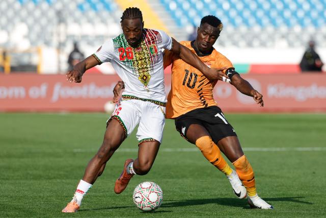 Mali's defender #26 Woyo Coulibaly (L) fights for the ball with Zambia's forward #10 Fashion Sakala (R) during the Africa Cup of Nations (AFCON) Group A football match between Mali and Zambia at Mohammed V Stadium in Casablanca, Morocco on December 22, 2025. (Photo by Abdel Majid BZIOUAT / AFP)