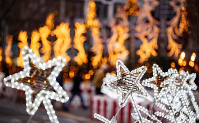 Christmas lights line the Christmas market around Berlin's Memorial church on the Breitscheidplatz on December 22, 2025. (Photo by John MACDOUGALL / AFP)