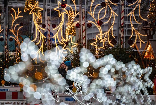 Christmas lights line the Christmas market around Berlin's Memorial church on the Breitscheidplatz on December 22, 2025. (Photo by John MACDOUGALL / AFP)