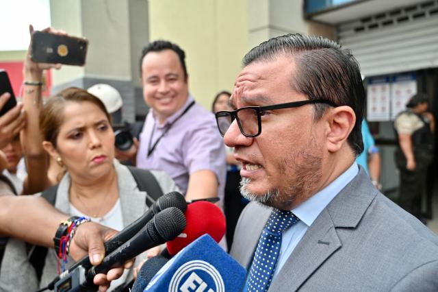 The lawyer of the relatives of four disappeared children, Abraham Aguirre, speaks to the press outside a court in Guayaquil, Ecduador, on December 22, 2025, after the sentence of the militarymen involved in the case was heard. Eleven Ecuadorian soldiers were sentenced to nearly 35 years in prison each for the forced disappearance of four minors, whose bodies were later found burned in 2024, the Attorney General's Office reported on Monday. (Photo by MARCOS PIN / AFP)
