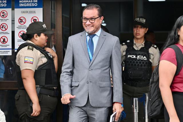 The lawyer of the relatives of four disappeared children, Abraham Aguirre, exits a court in Guayaquil, Ecduador, on December 22, 2025, after the sentence of the militarymen involved in the case was heard. Eleven Ecuadorian soldiers were sentenced to nearly 35 years in prison each for the forced disappearance of four minors, whose bodies were later found burned in 2024, the Attorney General's Office reported on Monday. (Photo by MARCOS PIN / AFP)