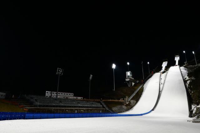 A photograph taken on December 22, 2025 shows the Ski Jumping arena, prior the Open Italian Championship of ski jumping, in Predazzo. The Ski Jumping arena in Predazzo will host the ski jumping and nordic combined competitions, during the Milano Cortina 2026 Winter Olympic Games. (Photo by Stefano RELLANDINI / AFP)