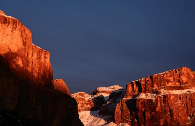 A photograph taken on December 22, 2025 shows the Dolomiti's Alps at the sunset from the Pordoi Pass. (Photo by Stefano RELLANDINI / AFP)