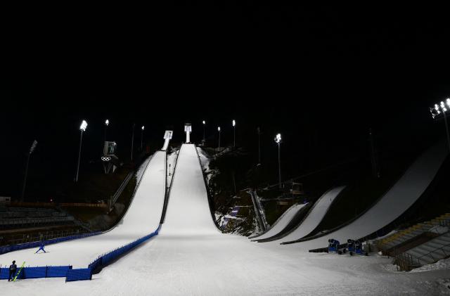 A photograph taken on December 22, 2025 shows the Ski Jumping arena, prior the Open Italian Championship of ski jumping, in Predazzo. The Ski Jumping arena in Predazzo will host the ski jumping and nordic combined competitions, during the Milano Cortina 2026 Winter Olympic Games. (Photo by Stefano RELLANDINI / AFP)