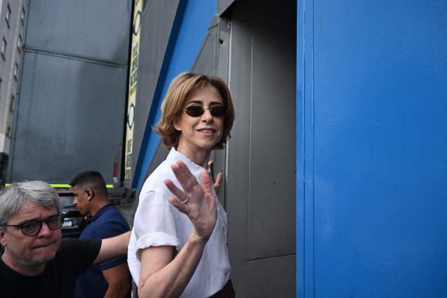 (FILES) Brazilian actress Fernanda Torres waves to journalists during a protest against the Brazilian Congress to reject a bill that would modify penalties for crimes against democracy and thus reduce the sentence of former president Jair Bolsonaro, at Copacabana Beach in Rio de Janeiro, Brazil on December 14, 2025. The famous flip-flop brand Havaianas faces a boycott call from Brazilian political figures in December 2025, after an advertisement was deemed anti-right as next year's presidential elections approach. In a video posted on the brand's account, Fernanda Torres, lead actress of the Brazilian film Ainda Estou Aqui (I Am Still Here), winner of the Oscar for Best International Feature Film, urges the public "not to start 2026 on the right foot" but "with both feet." (Photo by MAURO PIMENTEL / AFP)