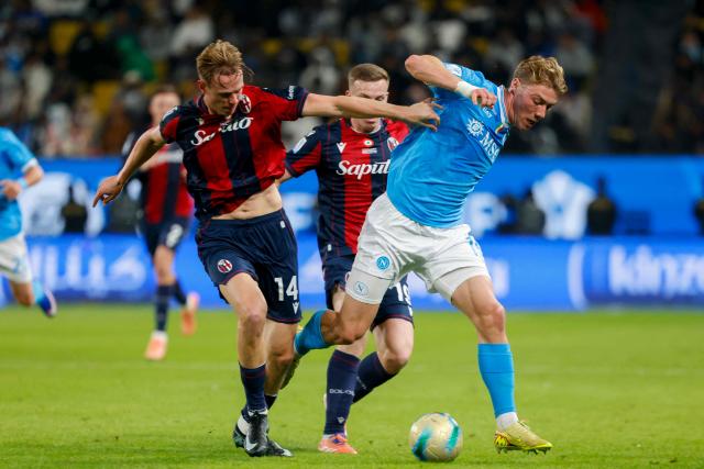 Bologna's Norwegian defender #14 Torbjorn Lysaker Heggem and Bologna's Scottish midfielder #19 Lewis Ferguson fight for the ball with Napoli's Danish forward #19 Rasmus Hojlund during the Italian Super Cup final match between SCC Napoli and Bologna at King Al-Awwal Park Stadium in Riyadh on December 22, 2025. (Photo by Fayez NURELDINE / AFP)