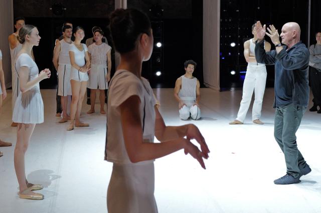 French dancer and choreographer Jean-Christophe Maillot (R) of the Monte-Carlo ballet speaks to dancers during the rehearsal of his creation "Ma Bayadere" ballet show, in Monaco on December 22, 2025. The show will take place from December 27, 2025 until January 4, 2026 at the Grimaldi Forum in Monaco. (Photo by Valery HACHE / AFP)
