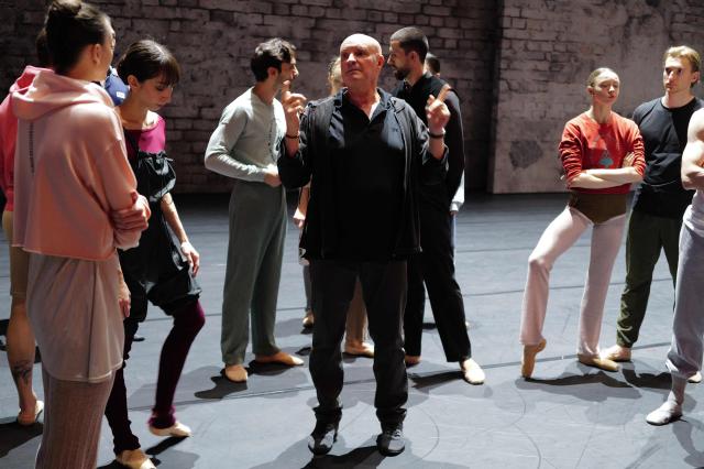 French dancer and choreographer Jean-Christophe Maillot (R) of the Monte-Carlo ballet speaks to dancers during the rehearsal of his creation "Ma Bayadere" ballet show, in Monaco on December 22, 2025. The show will take place from December 27, 2025 until January 4, 2026 at the Grimaldi Forum in Monaco. (Photo by Valery HACHE / AFP)