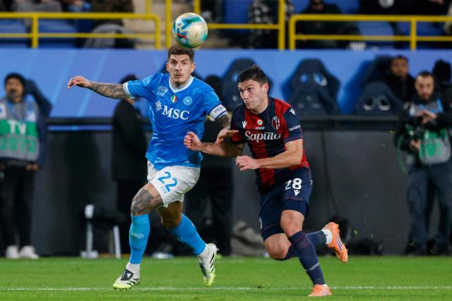 Napoli's Italian defender #22 Giovanni Di Lorenzo fights for the ball with Bologna's Italian forward #28 Nicolo Cambiaghi during the Italian Super Cup final match between SCC Napoli and Bologna at King Al-Awwal Park Stadium in Riyadh on December 22, 2025. (Photo by Fayez NURELDINE / AFP)
