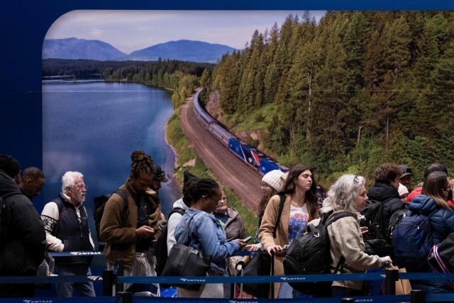 People wait to board a train at Union Station on December 22, 2025, in Washington, DC. (Photo by Brendan Smialowski / AFP)