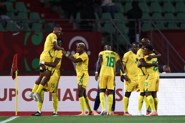 Zimbabwe's forward #07 Prince Dube (L) celebrates scoring the team's first goal during the Africa Cup of Nations (CAN) group B football match between Egypt and Zimbabwe at Adrar Stadium in Agadir on December 22, 2025. (Photo by FRANCK FIFE / AFP)