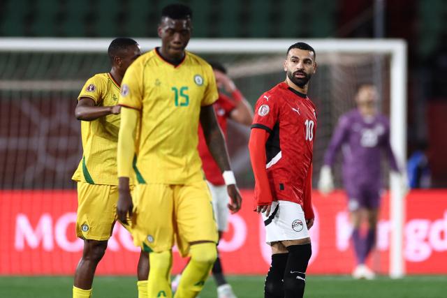 Egypt's forward #10 Mohamed Salah (R) reacts after Zimbabwe's forward #07 Prince Dube (unseen) scored the first goal during the Africa Cup of Nations (CAN) group B football match between Egypt and Zimbabwe at Adrar Stadium in Agadir on December 22, 2025. (Photo by FRANCK FIFE / AFP)