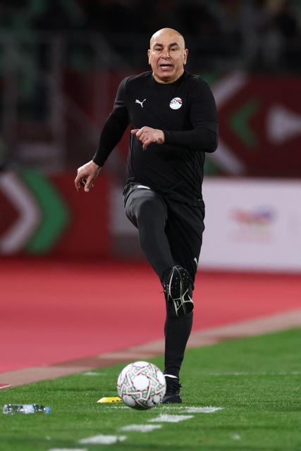 Egypt's head coach Hossam Hassan kicks the ball during the Africa Cup of Nations (CAN) group B football match between Egypt and Zimbabwe at Adrar Stadium in Agadir on December 22, 2025. (Photo by FRANCK FIFE / AFP)