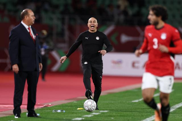 Egypt's head coach Hossam Hassan (C) kicks the ball during the Africa Cup of Nations (CAN) group B football match between Egypt and Zimbabwe at Adrar Stadium in Agadir on December 22, 2025. (Photo by FRANCK FIFE / AFP)