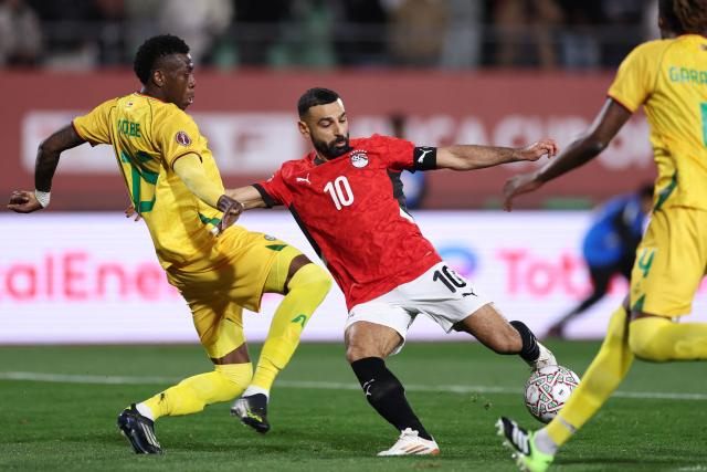 TOPSHOT - Egypt's forward #10 Mohamed Salah scores the team's second goal during the Africa Cup of Nations (CAN) group B football match between Egypt and Zimbabwe at Adrar Stadium in Agadir on December 22, 2025. (Photo by FRANCK FIFE / AFP)