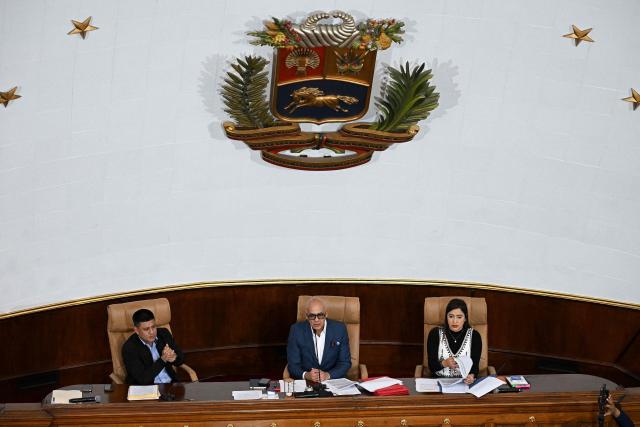 Venezuela's National Assembly President Jorge Rodriguez (C) speaks next to First Vice President Pedro Infante (L), and Second Vice President America Perez during a extraordinary session at the National Assembly in Caracas on December 22, 2025. (Photo by Federico PARRA / AFP)